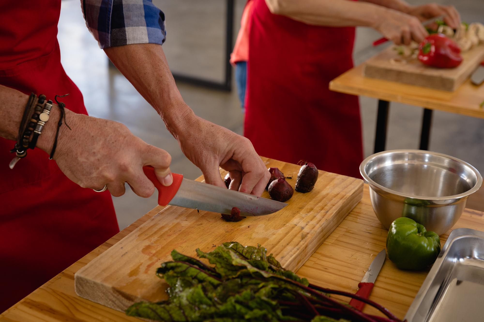 Chef demonstrating knife skills to small group
